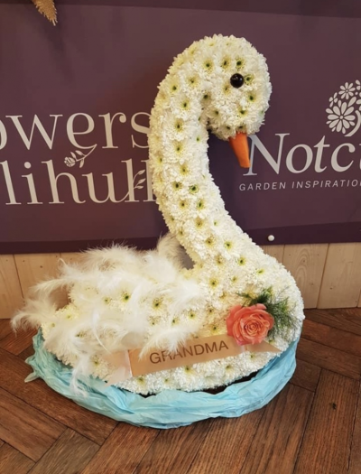 Swan - A white swan based in white chrysanthemums and sprayed to give effect and definition.