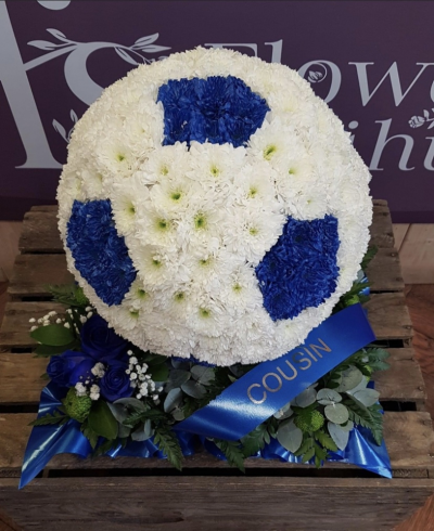 Football. - Football.  Based in white chrysanthemums and hexagons sprayed either in black or the colour of your choice. Finished with a floral spray in the colour of your choice.
