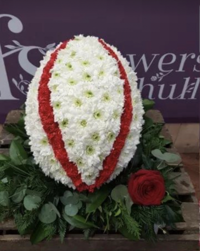 Rugby Ball. - A Rugby Ball oasis.  Based in White chrysanthemums and finished with stripes (as in the picture) or as the clubs ball.