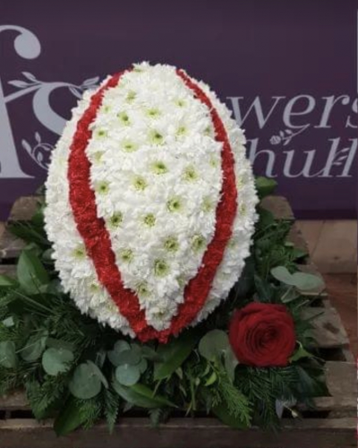 Rugby Ball. - A Rugby Ball oasis.  Based in White chrysanthemums and finished with stripes (as in the picture) or as the clubs ball.
