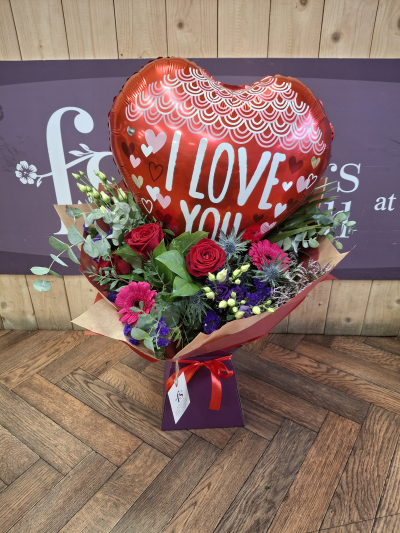 Love is in the air - A valentines helium balloon arranged within a handtied bouquet of flowers .Containing 3 red roses with a selection of other flowers to create this delightful display .Hand delivered to your valentine .