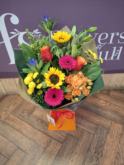 Carnival vibes - A front facing handtied bouquet of vibrant colours created by our florists hand delivered .