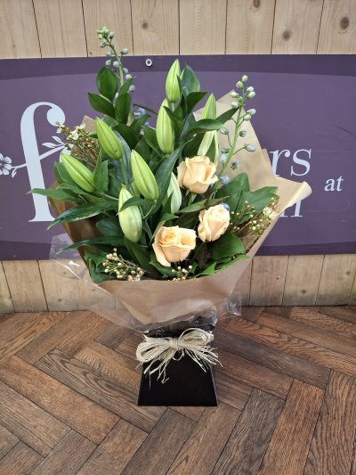 Cookies and cream - A most elegant front facing bouquet, handtied with a mix of white Lillie's, peach roses and other subtle tones .Delivered by hand .