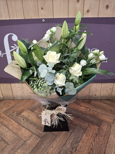 Beauty - A front facing hantied bouquet white Lillie's, roses and lizzianthus .Handtied by one of our florists, hand delivered.